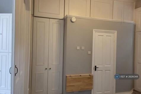 Bathroom Door In Living Room, Built In Cupboards 