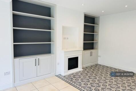 Family Room Has An Electric Fire And Bookshelves