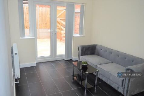 Open Plan Lounge With Doors Leading To Rear Garden
