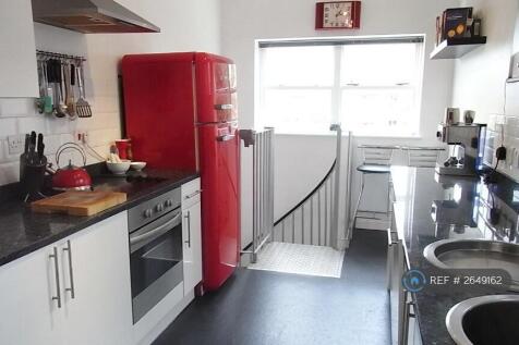 Large Kitchen With Spiral Stairs To Utility