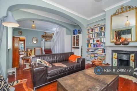 Double Reception Room With Its Sweeping Staircase