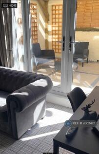 Lounge With French Doors To Large Courtyard Garden