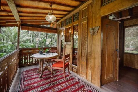 A cozy wooden balcony features a round table with