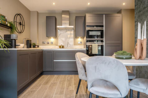 Image showcasing the stylish midnight blue kitchen with dining table and 4 chairs in the open-plan l
