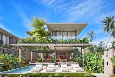 Modern villa with open design, surrounded by lush