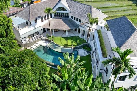 Luxurious estate with a stunning pool and lush tro