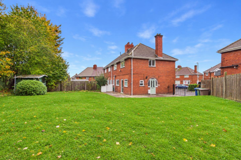 Sunny Suburban Backyard with Brick House.png