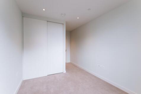 Experience tranquility in this sleek minimalist bedroom, perfect for relaxation.