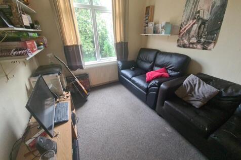 Cozy living room featuring comfortable black le...