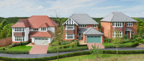 Three modern detached houses with brick exteriors and grey tiled roofs, surrounded by lush greenery