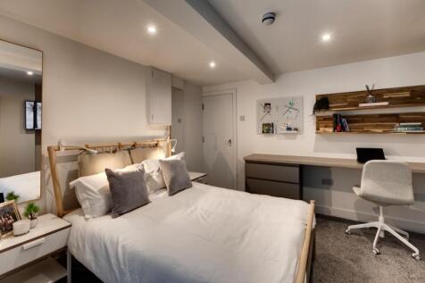 Bright, modern bedroom with a comfortable doubl...