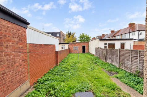 Bright Suburban Garden with Brick Shed.png