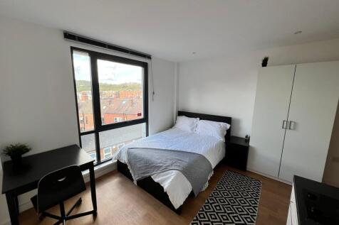 Bright, modern double bedroom with large floor-...