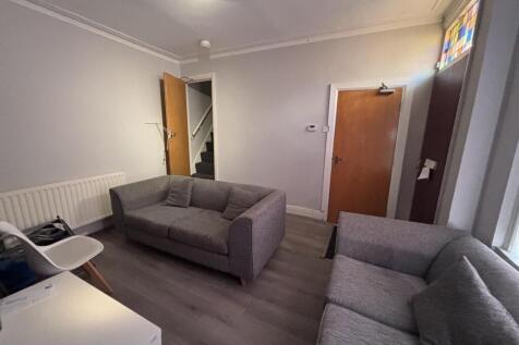 A bright and welcoming living room featuring co...