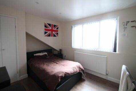 Cozy bedroom with a large window allowing ample...