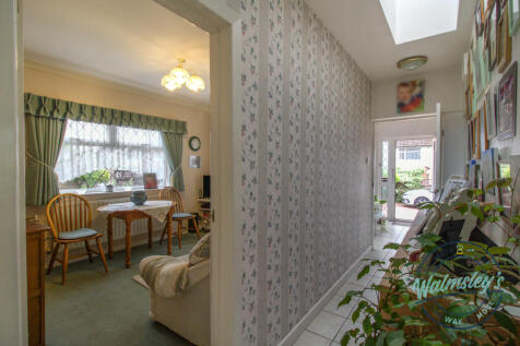 Hallway towards utility &amp; front door with bedroom 