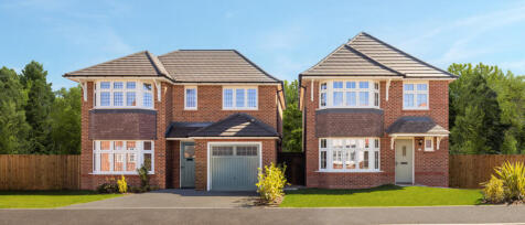 Two new-brick detached family houses with bay windows, grey roofs, front lawns, and wooden fencing u