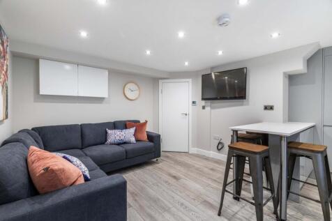 A spacious and modern living room featuring a l...