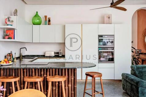 Modern kitchen with sleek white cabinetry and a st