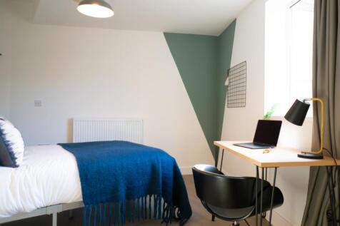 A bright and modern double bedroom featuring a ...