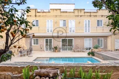 A serene backyard view with a swimming pool, surro