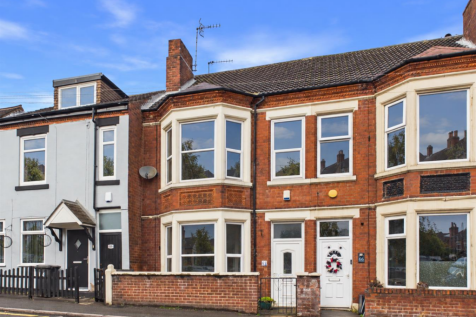Red brick home with clear bay windows.png
