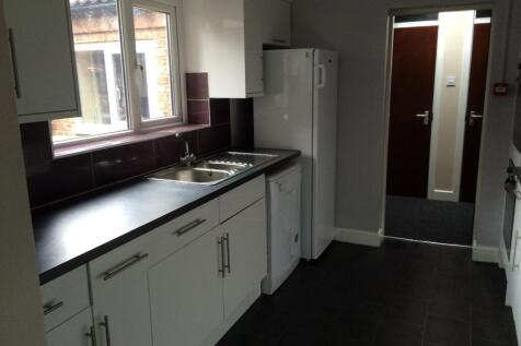 A modern and tidy kitchenette with ample storag...