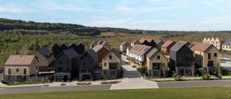 Modern detached and semi-detached houses in a new residential development with landscaped gardens an