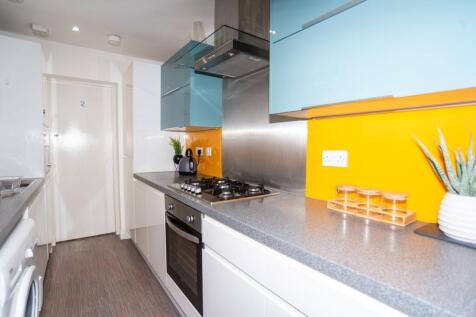 Modern galley kitchen with sleek grey worktops,...