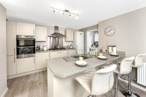 kitchen with cabinets and island with stools