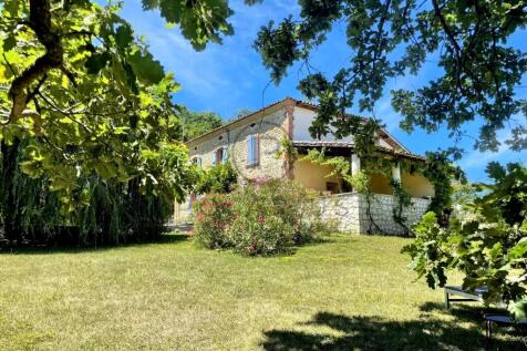 A charming stone house surrounded by a lush garden