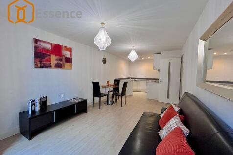 A bright and generously sized one-bedroom apartment featuring a stylish open-plan kitchen and living area, seamlessly extending onto a private balcony overlooking the courtyard, offering a peaceful an