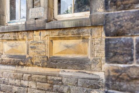 Stone Lozenges Beneath Windows