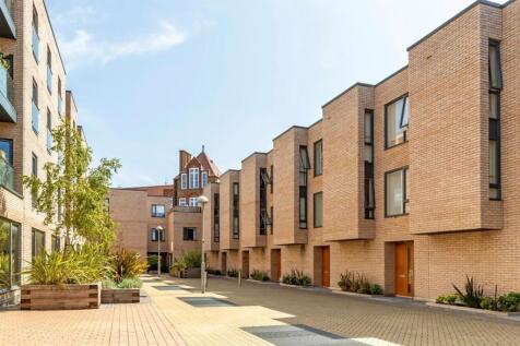 A modern three-bedroom townhouse with an additional study room, private garden and underground parking space, in a secure gated development in Brackenbury Village. This property would make the perfect