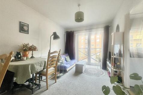 Bright lounge with dining area and balcony acce...