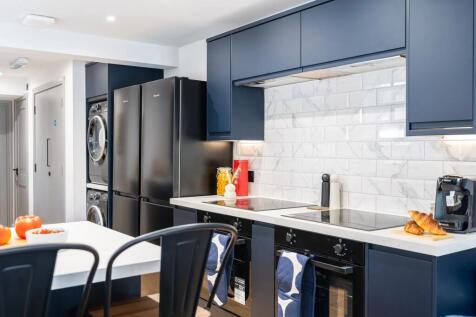 Modern and stylish kitchen with sleek navy cabi...