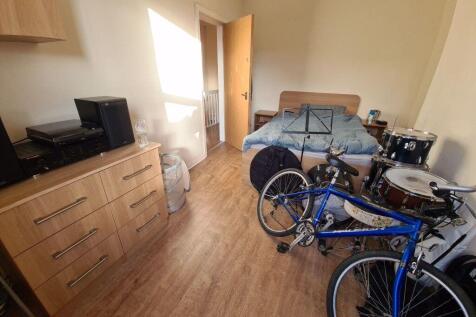 A cozy living room featuring a sofa, various mu...