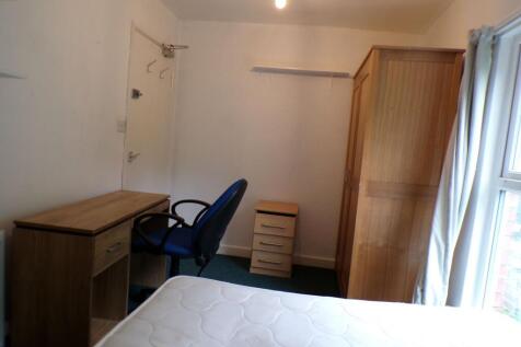 Bright single bedroom with a large window and n...