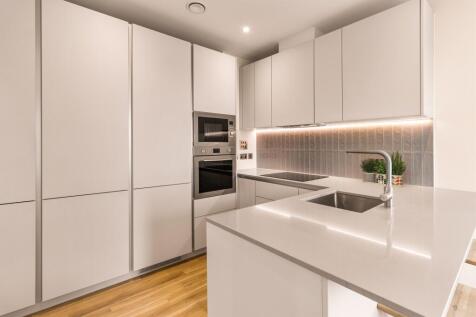 Experience the elegance of this sleek modern kitchen designed for culinary enthusiasts.