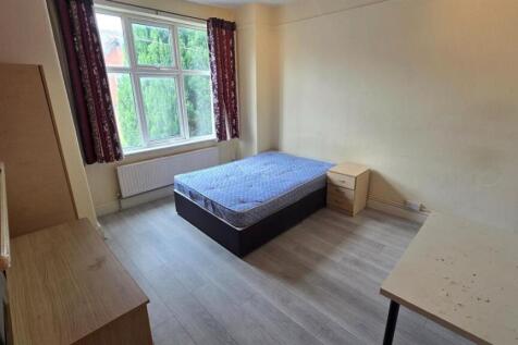 Bright, simply furnished bedroom with a large w...