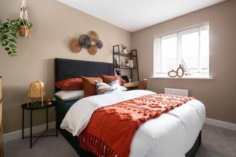 An inviting second bedroom with a double bed, perfect for guests or family members.
