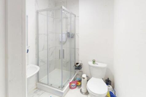 A clean and functional bathroom featuring a sho...