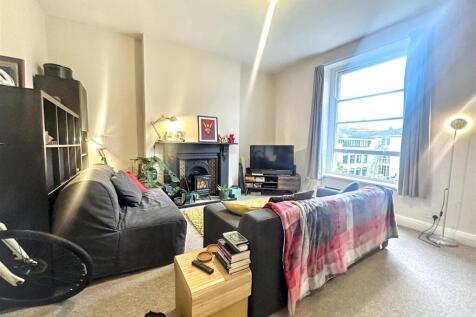 Bright lounge with feature fireplace and window...