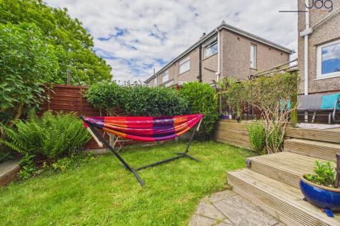 Tiered Garden with a mixture of flags, decking and lawn.