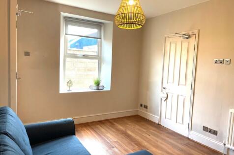 A bright, inviting living room featuring a larg...