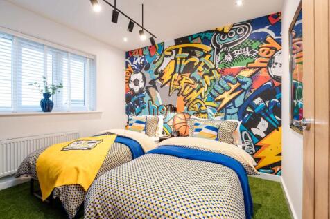 Two beds with colorful bedding are in the foreground