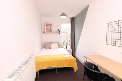 A bright and inviting double bedroom with moder...