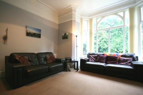 A spacious and well-lit living room featuring t...