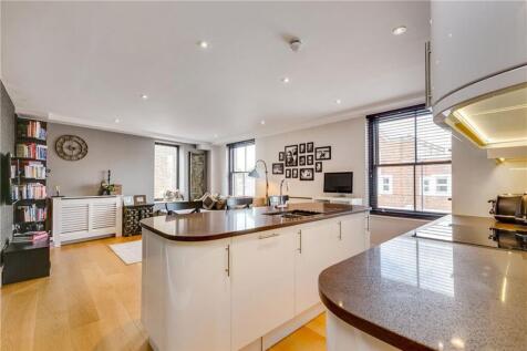 This beautifully presented apartment features a bright, dual-aspect open-plan kitchen and reception room, flooded with natural light. The contemporary kitchen is finished to a high standard with integ
