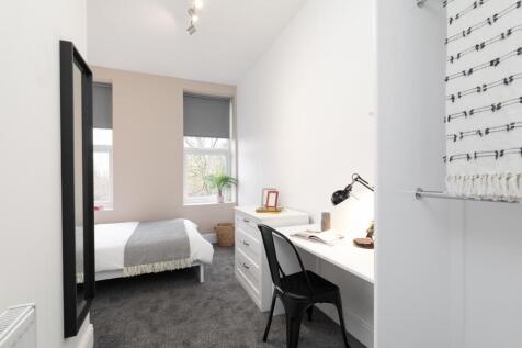 Bright, neatly presented bedroom with a comfort...